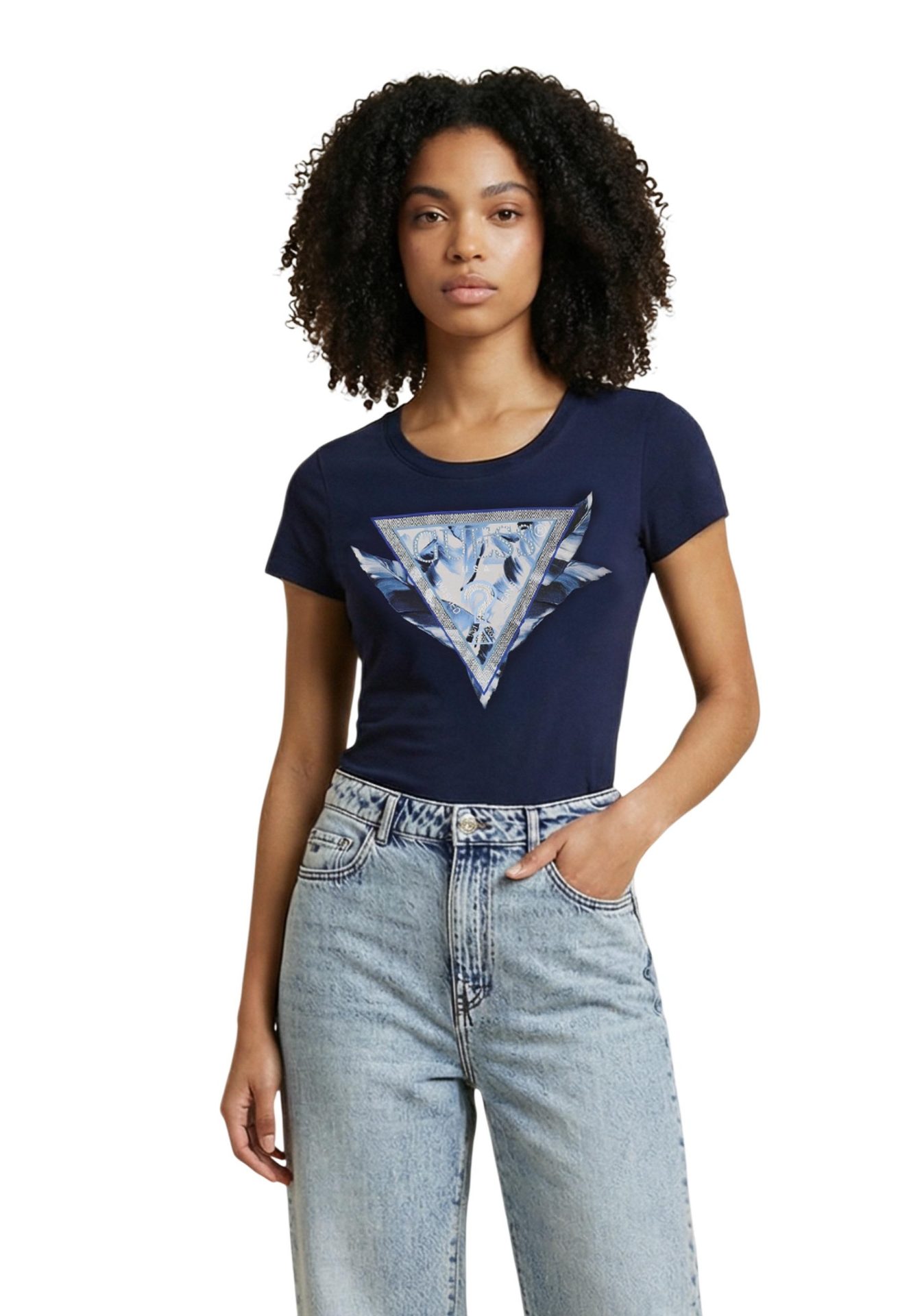 Woman wearing a navy blue t-shirt with a Guess triangle graphic and light-wash jeans