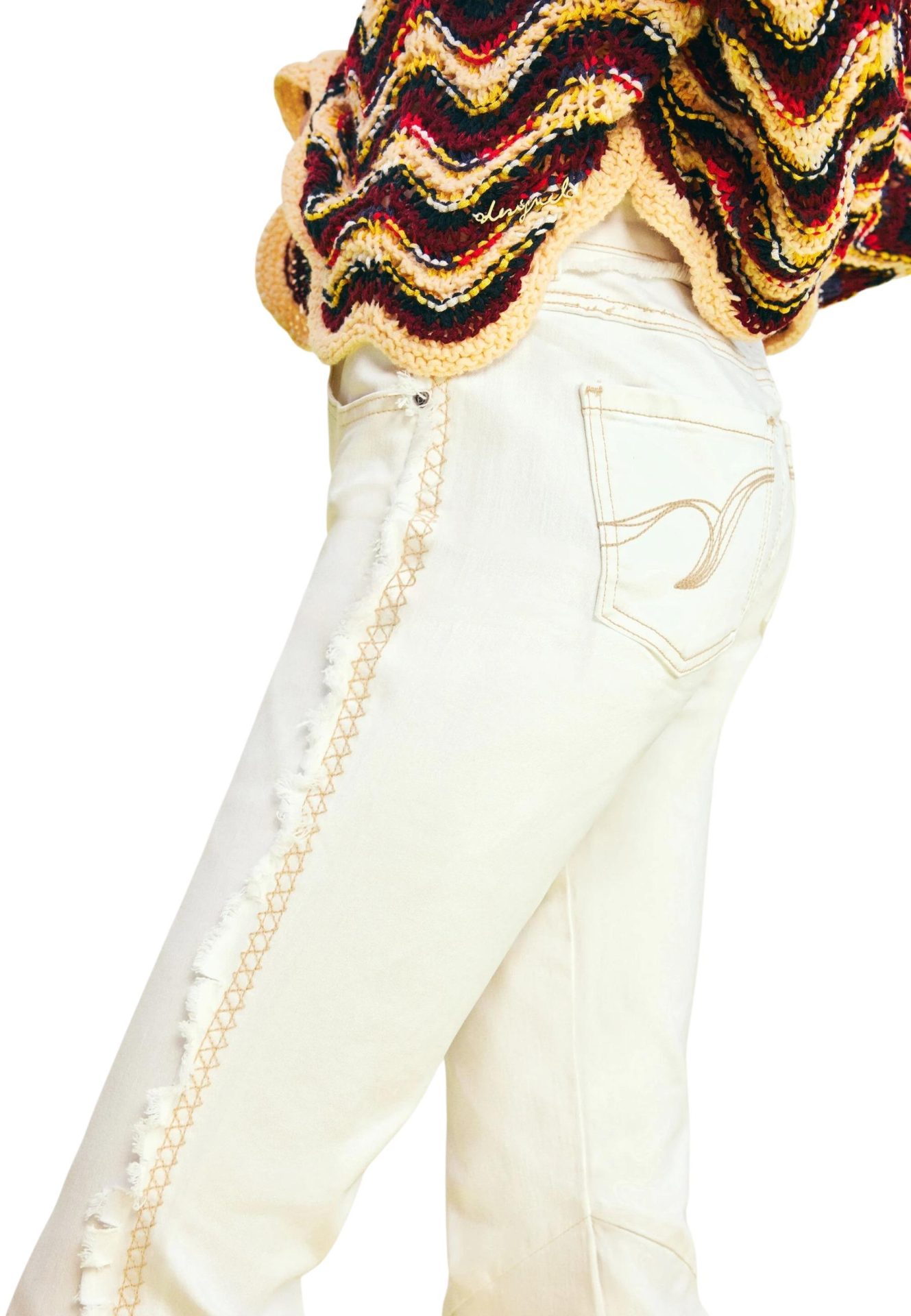 White jeans featuring a frayed side seam with tan cross-stitch embroidery and a back pocket design
