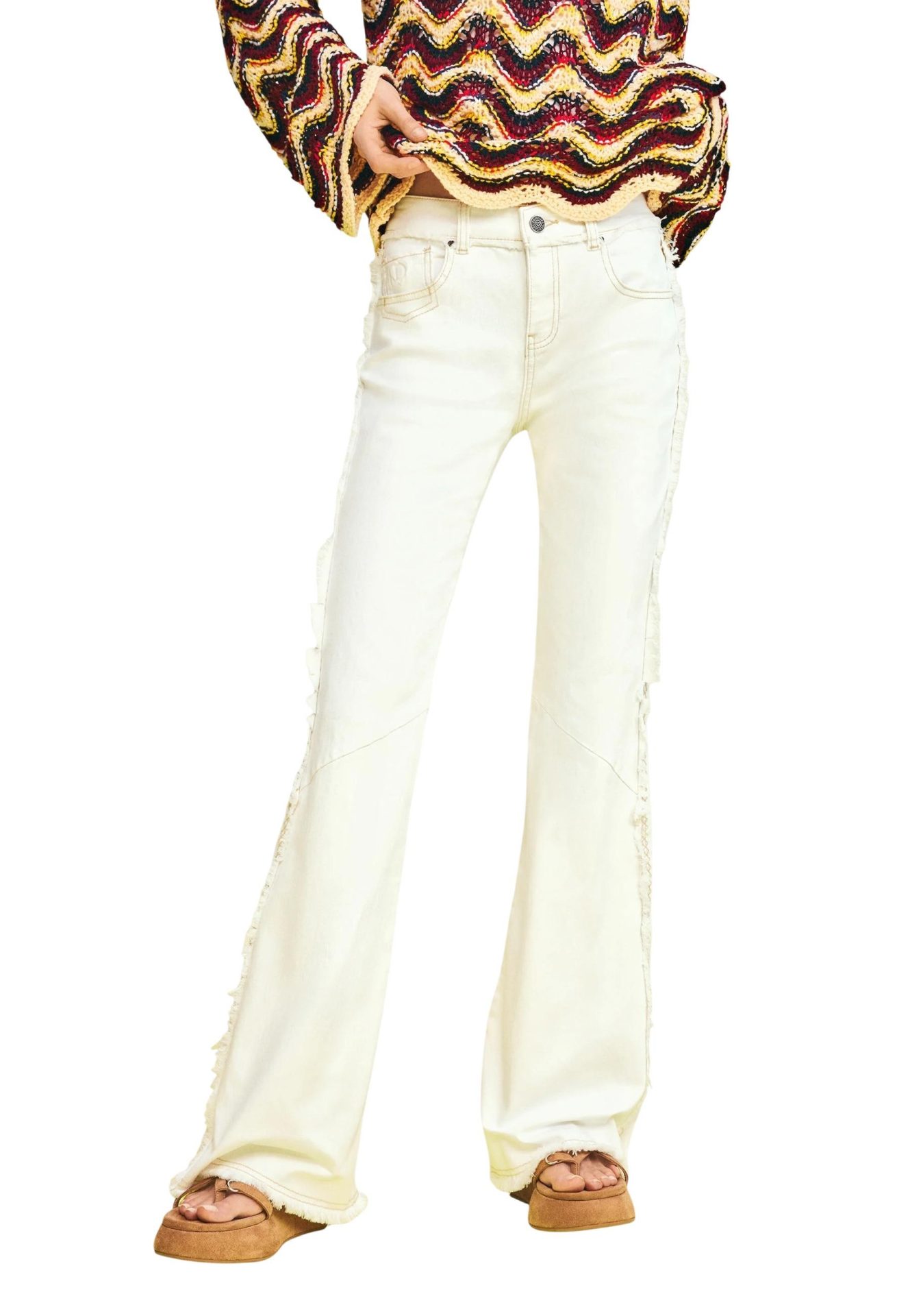 High-waisted off-white flare jeans with frayed side seams, paired with a colorful knit sweater