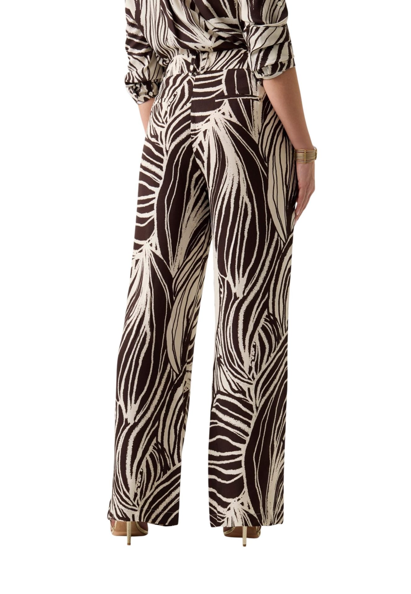 Back view of wide-leg trousers in a bold brown and cream abstract leaf print