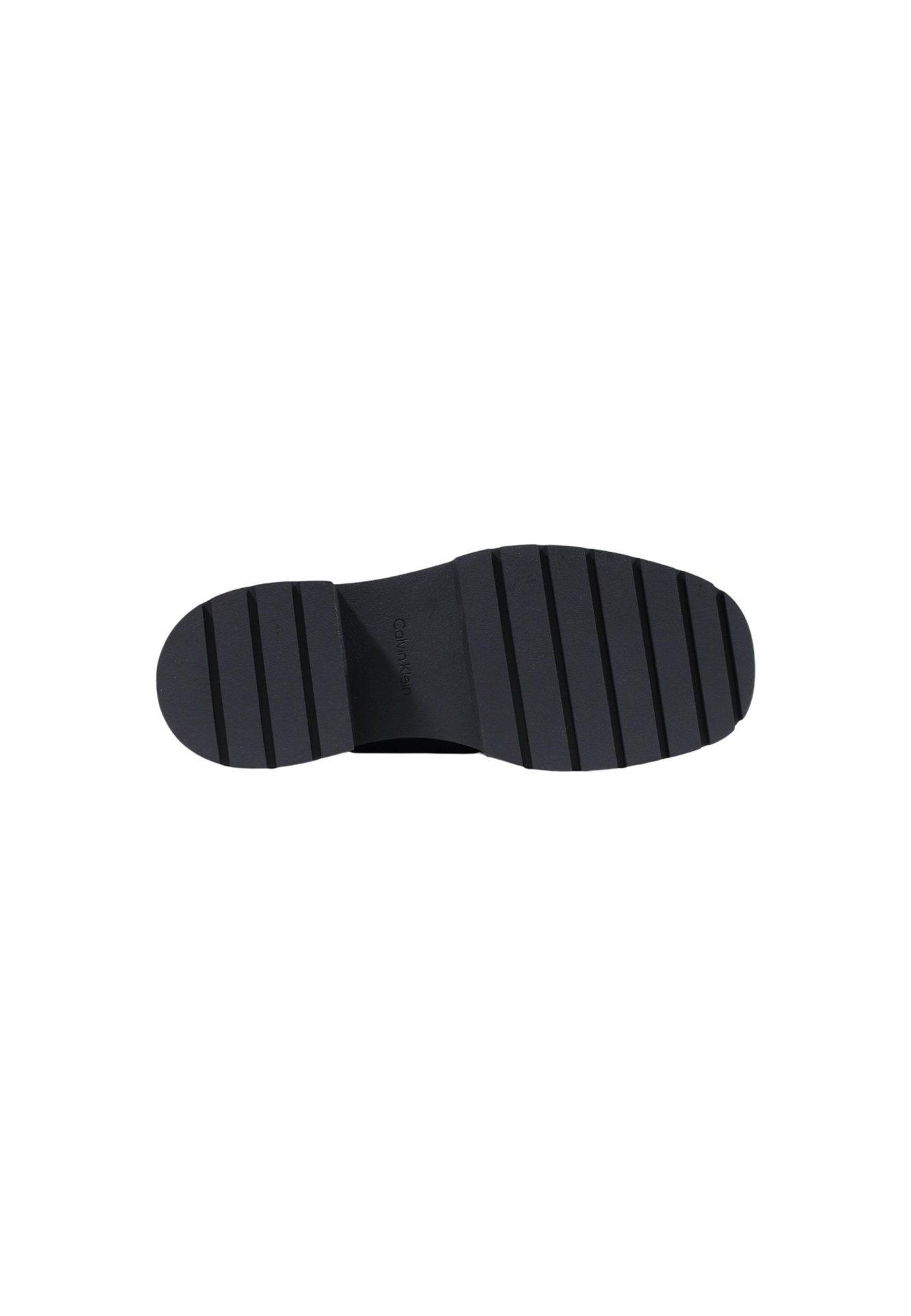 Black lug sole of a Calvin Klein shoe, featuring a thick, ridged tread pattern